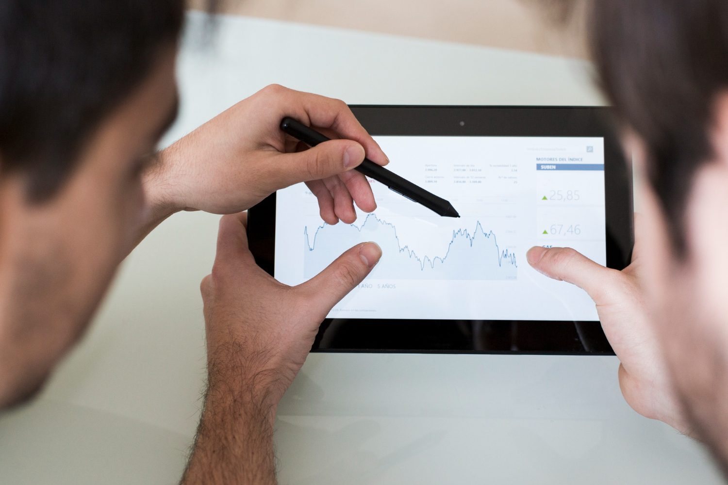 Team analyzing blog analytics metrics on a tablet